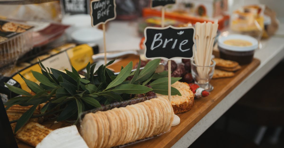 A delicious gourmet cheese platter featuring Brie cheese, crackers, and charcuterie.